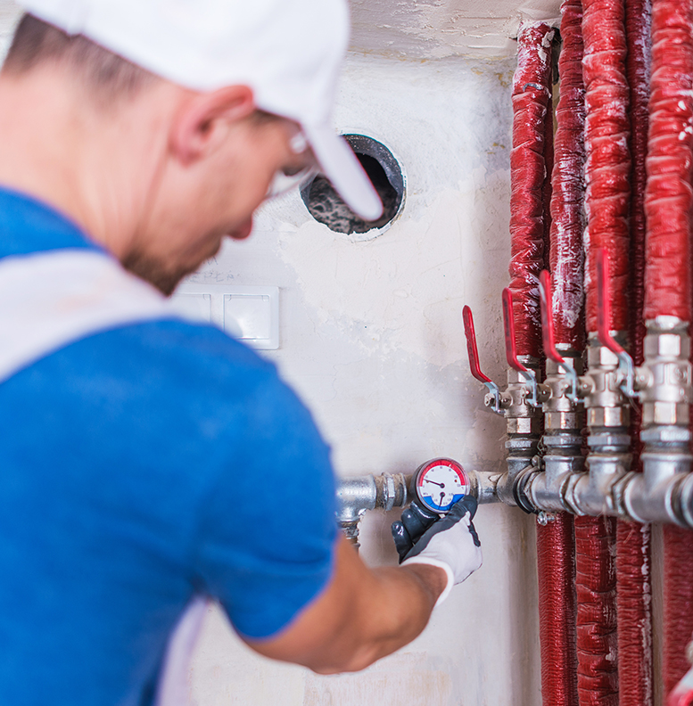 Caucasian Plumber Checking on the New Residential Water Supply System.